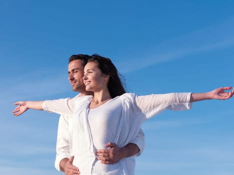 happy young romantic couple in love have fun on beautiful beach at beautiful summer day