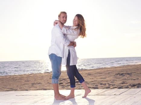 happy young romantic couple in love have fun on beautiful beach at beautiful summer day