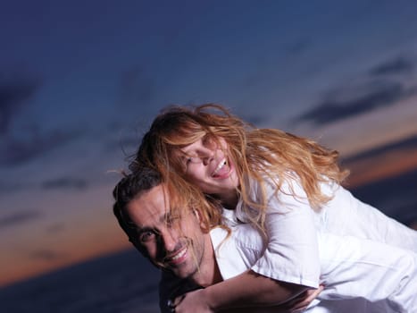 happy young romantic couple in love have fun on beautiful beach at beautiful summer day