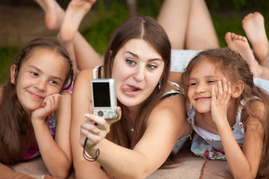 Closeup portrait of mother and daughters making faces on self shot