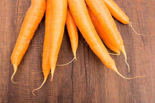 Close-up carrots in orange on board of wood