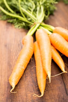 Carrots with green in portrait format