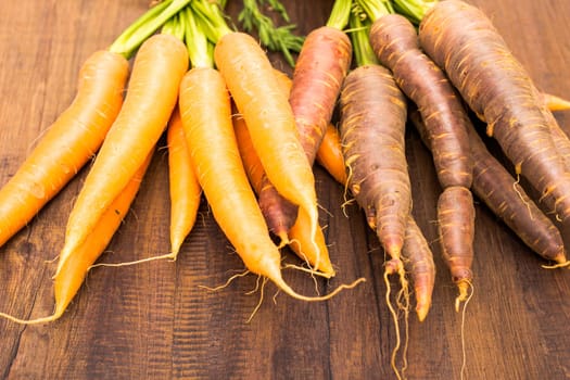 Urcarrots and carrots on a wooden board