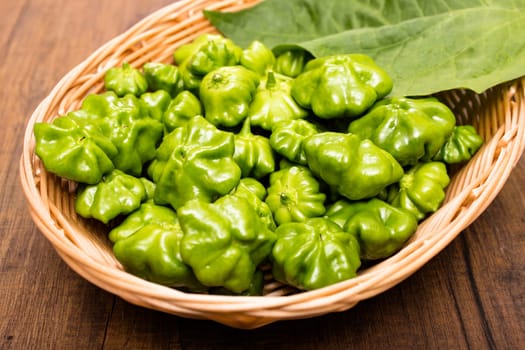 Green spicy chilli peppers in a basket