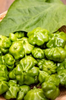 Green chili peppers with leaf in portrait format