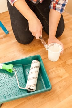 Closeup shot of woman painter doing renovation with tools