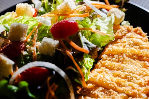 Crispy pork cutlet and fresh vegetables salad. Healthy fresh salad.