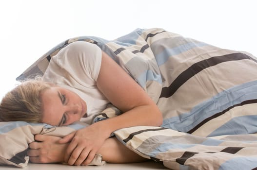young woman sleeping in bed on white background