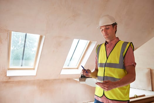 Building Inspector Looking At New Property