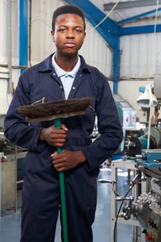 Apprentice In Engineering Factory Sweeping Floor
