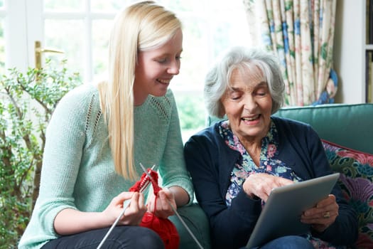 Grandmother Using Digital Tablet Asd Granddaughter Knits