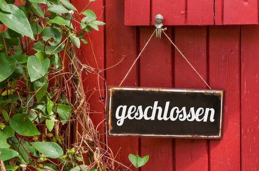 Old tin sign with inscription closed