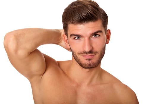 attractive muscular young man with free torso and beard isolated against white background