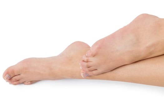 Woman with neatly groomed natural nails without varnish shows off her feet in a beauty concept on a white background