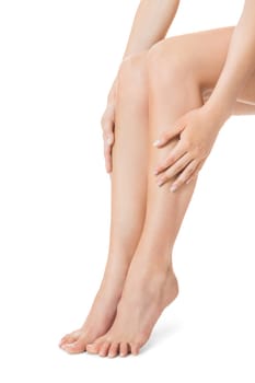 Elegant long shapely naked female legs with bare feet insulated on white with text space