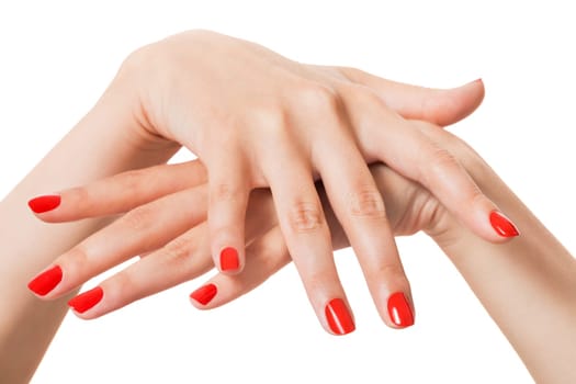 Women's hands with beautiful manicured fingers and red nail polish wellness beauty spa close-up isolated on white background