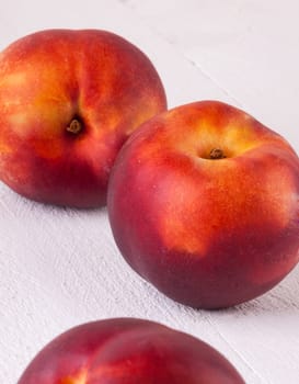 Fresh nectarines,oranges,peaches close-up on white background