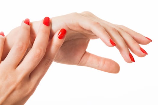 Women's hands with beautiful well-groomed fingers and red nail polish wellness beauty spa close up isolated on white background