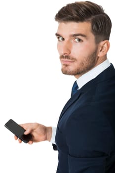 Young businessman chatting on his phone smartphone with a beaming smile of joy isolated on white background