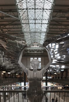 London, UK - Oct 13, 2023 - The angel of london (love & hope) Interior the very heart of new battersea power station in a life size maquette sculpture in hand polished mirror stainless steel. The angel sculpture, Space for text, Selective focus.