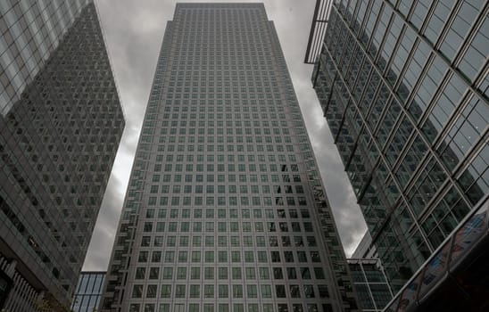 London, England - Oct 16, 2023 - Upward view of Skyscrapers in the business district area of One Canada Square in Canary Wharf. Tall structure architecture in the capital city. Architectural exterior view, Copy space, Selective focus.