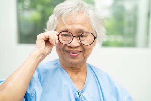 Asian senior woman wearing eyeglasses or vision glasses at home care service.