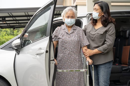 Asian senior woman patient walk with walker prepare to get her car.