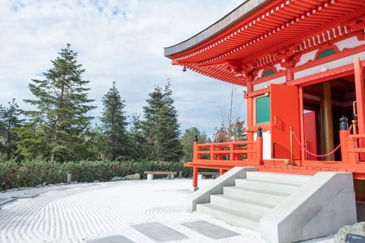 red pagoda with nature background and white zen rocks and sand, architecture details