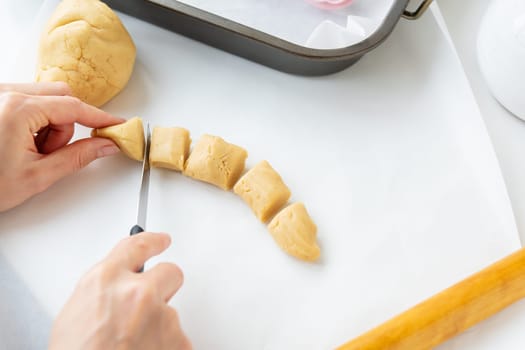 The process of making cookies with shapes in the form of flowers, a rolling pin and a tray, the concept of cooking, baking at home