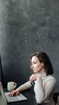 Young Woman's Online Shopping. Holding Credit Card and Using Laptop Computer. Young woman holding credit card and using laptop computer. Online shopping concept.