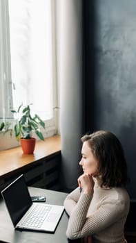 Effortless Online Shopping. Young Woman with Credit Card and Laptop. Young woman holding credit card and using laptop computer. Online shopping concept