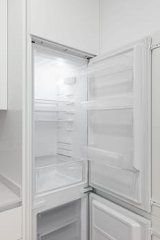 A white refrigerator with open doors in a kitchen