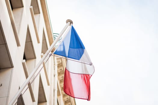 French flag on a flagpole at a building in Paris,France