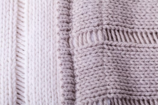 Close-up of a bright fabric tructure knitted from wool background