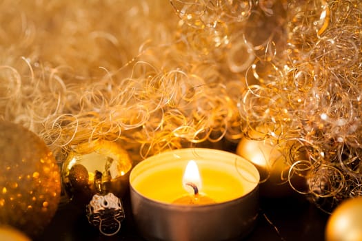 Warm golden and orange Christmas decoration with candlelight as close-up in context