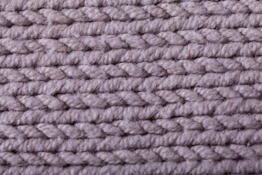 Close-up of a bright fabric tructure knitted from wool background