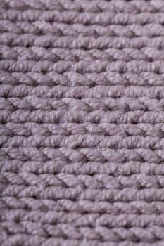 Close-up of a bright fabric tructure knitted from wool background