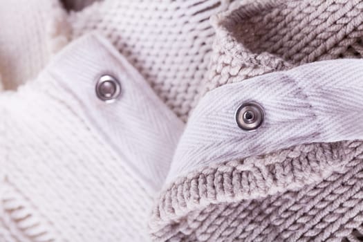 Close-up of a bright fabric tructure knitted from wool background