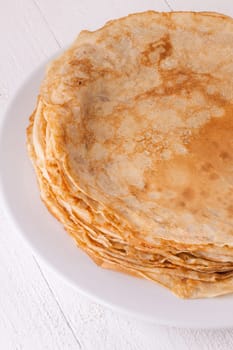 delicious fresh crepes pancakes pancakes on a white plate on a rustic white wooden board