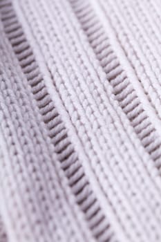 Close-up of a bright fabric tructure knitted from wool background