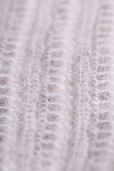 White knitted fabric wool with structure fluffy soft as close-up