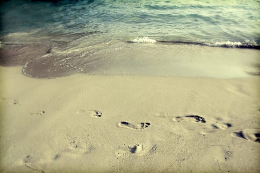 Footsteps in the sand on the beach