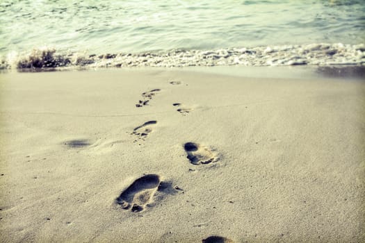 Footsteps in the sand on the beach