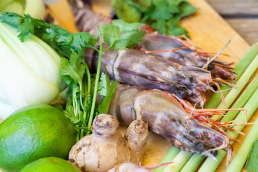 Ingredients for Tom Yam soup with lemongrass shrimp coriander on a kitchen board