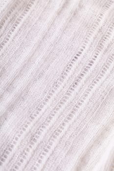 White knitted fabric wool with structure fluffy soft as close-up