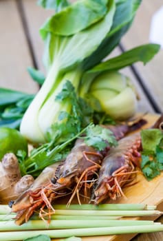 Ingredients for Tom Yam soup with lemongrass shrimp coriander on a kitchen board