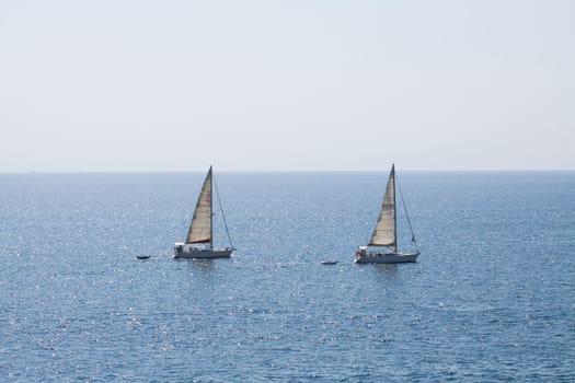 Sailing boat yacht or sailboat group regatta race on sea or ocean water. Panoramic view.