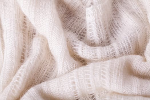White knitted fabric wool with structure fluffy soft as close-up