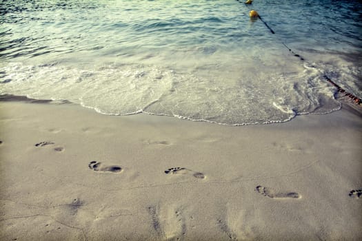 Footsteps in the sand on the beach
