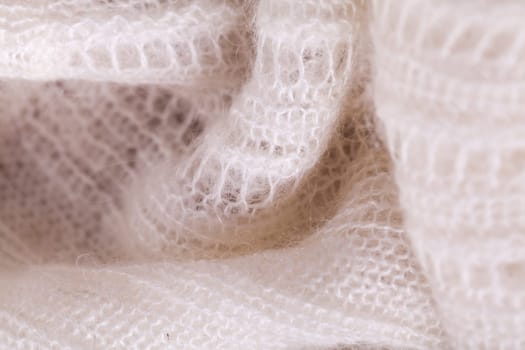 White knitted fabric wool with structure fluffy soft as close-up